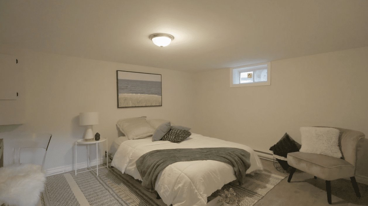 Cozy bedroom with neutral tones and soft lighting.