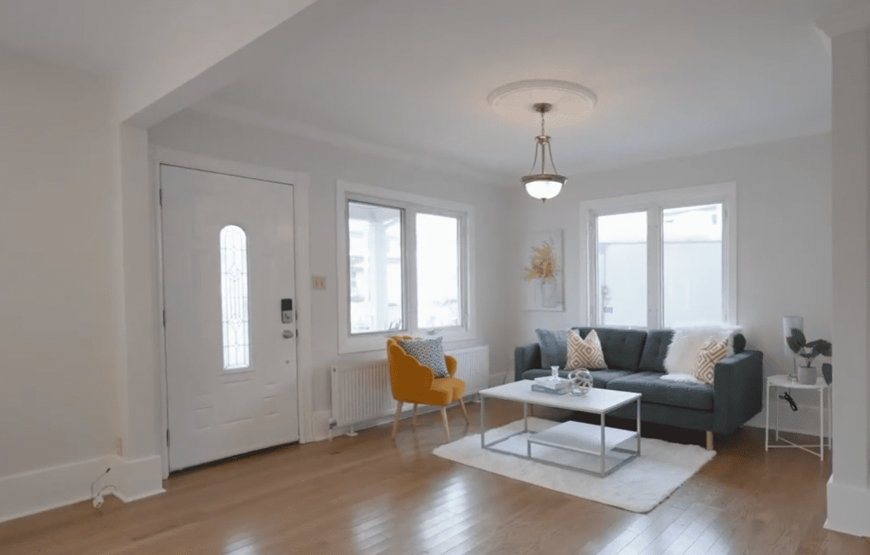 Bright living room with modern furniture and large windows.